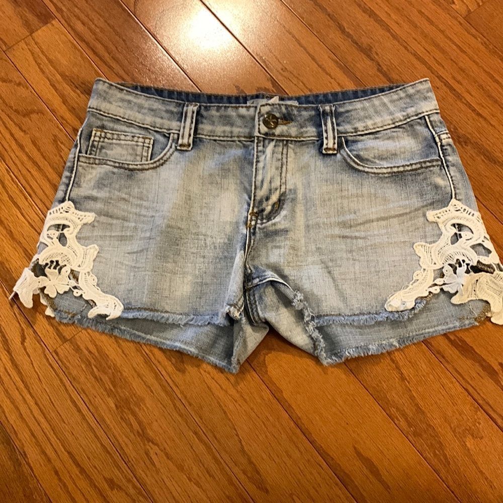 Others follow size 28 denim short shorts with distressed crochet detail